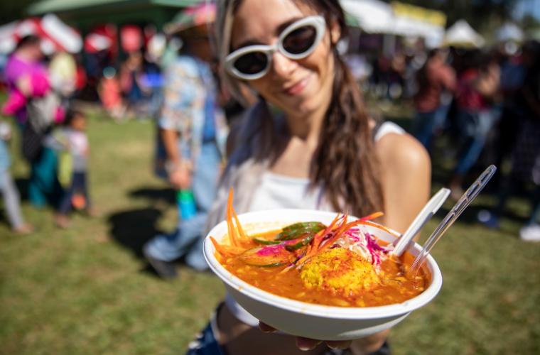 A woman showing her food at a Louisiana festival.