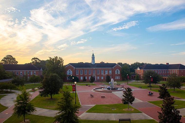 An overhead view of the University of Louisiana at Lafayette Quad with the fleur de lis fountain and Stephens Hall at sunset